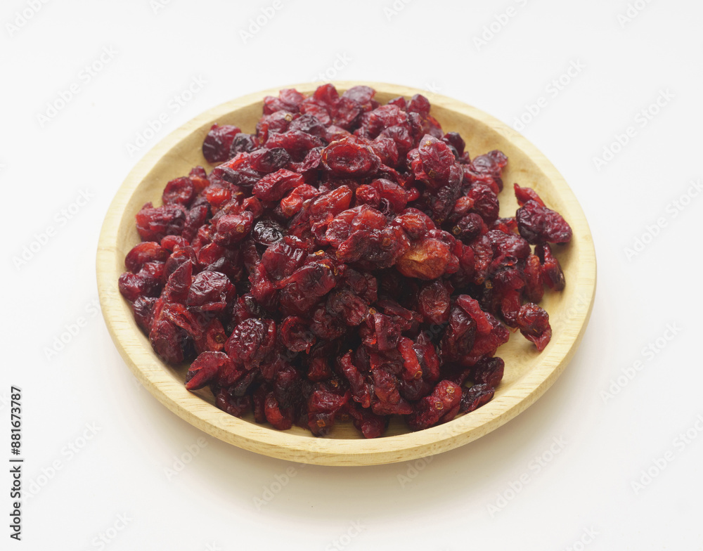 Poster Close-up of stacked dried raspberry with red fruits on wood tray and white floor, South Korea
