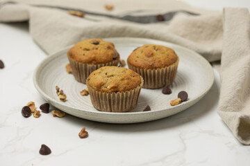 Three muffins served on a small plate