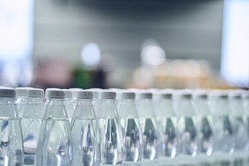 Water bottles in the supermarket. Clean drinking water in plastic bottles on the store counter. With space to copy. High quality photo