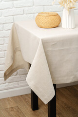 White Brick Wall With Beige Tablecloth and Basket