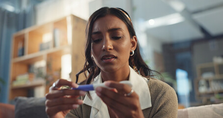 Girl, home and sad with pregnancy test on couch for negative results on ovulation stick, unhappy and fertility concern. Woman, emotional and disappointed on sofa for trying to conceive and news.