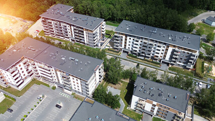 Contemporary low-rise apartments with greenery in European city aerial view