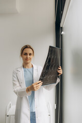 Female doctor checking anatomy and physiology x-ray film of patient in the hospital. Doctor...