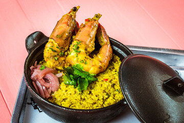 rice cooked in Lemak Chilli Padi sauce with tiger prawns and  pickled onions on top