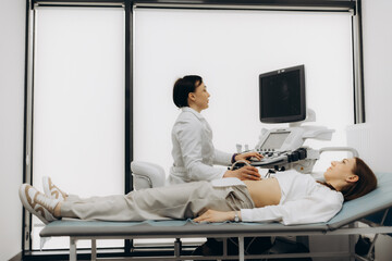 Doctor conducting ultrasound examination of woman in clinic