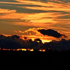 The sun sets behind the clouds on the horizon. Front view. German. Esslingen am Neckar