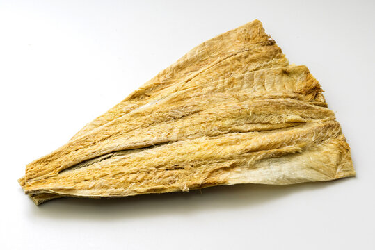 Close-up of two trimmed Hwangtae(dried pollack) on white floor, South Korea
