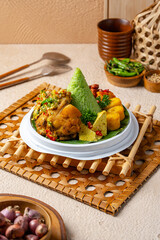 Tumpeng is an Indonesian cone-shaped rice dish with side dishes of vegetables and meat originating from Javanese cuisine of Indonesia.