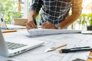 Architect or engineer working on blueprint at office desk, Construction concept.