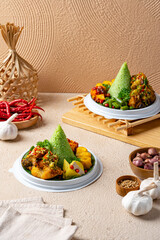 Tumpeng is an Indonesian cone-shaped rice dish with side dishes of vegetables and meat originating from Javanese cuisine of Indonesia.