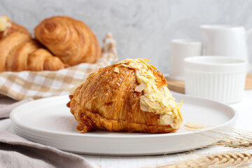 Freshly baked almond Croissant on the table. Perfect for recipe, article, catalogue, packaging, or any commercial purposes. 