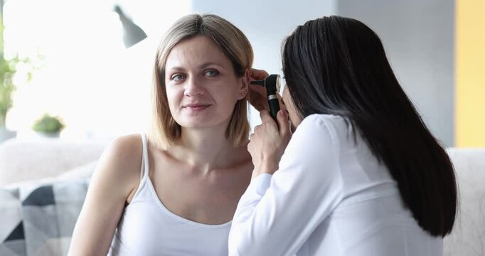 Otolaryngologist checking patient ears and examining hearing and ear volume in clinic. Audiologist and hearing test. Otorhinolaryngology and medical concept