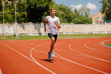 Young male athlete running on a track