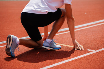Athlete in starting position on running track