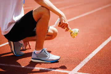 Athlete with trophy on running track