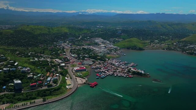Walter Bay speed boat Port Moresby Papua New Guinea parallax aerial drone capital city Harbour Marina PNG beautiful sunny blue sky morning islands Ela Beach Crown Hotel Plaza Hilton Coral Sea forward