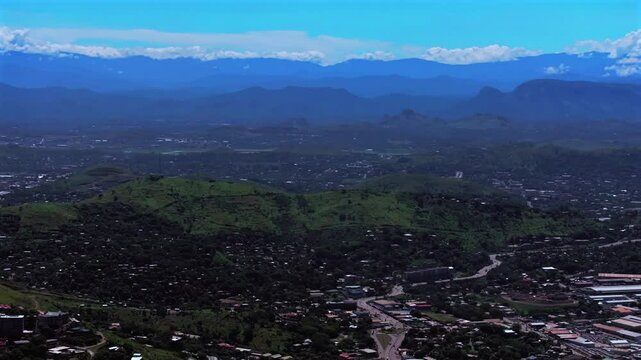 Port Moresby capital city business district traffic car highway Papua New Guinea aerial drone Ela Beach Harbour Marina PNG beautiful sunny blue sky morning Crown Hotel Plaza Hilton Coral Sea backwards