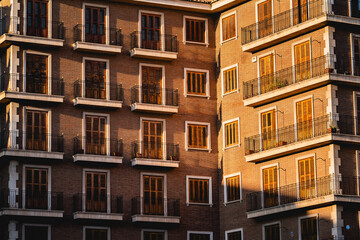 Obraz premium Portuguese exterior apartment facade with fine Portuguese architecture and balcony during sunset