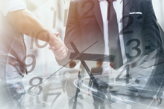 Business time fast moving speed working hours concept. Business people dealing project hand shaking overlay clock face.