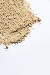 Ground dry ginger root on a white background, place for text