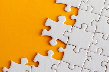 Obraz premium Jigsaw puzzle with an orange piece on a solid background, symbolizing successful job candidate the confidence. Standing out from the crowd. Copy space for text
