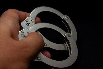 handcuffs in hand