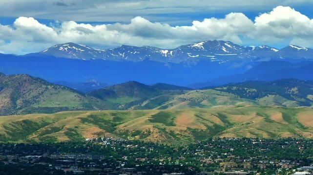 Summer Denver Colorado aerial drone parallax Golden Arvada Lakewood sunny front range foothills landscape Mount Blue Sky Red Rocks Amphitheater neighborhood homes clouds backwards pan reveal