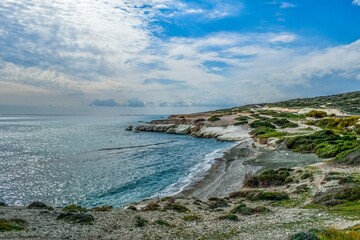 Serene Coastal Landscape with Rocky Cliffs and Blue Waters