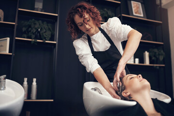 Hairdresser, massage and wash customer hair, salon and treatment with tap and basin with soap. Hands, scalp clean or hairstyle for happy female person, keratin and sulphate free shampoo for haircare
