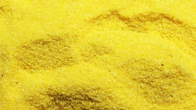 uncooked polenta with wooden spoon., video