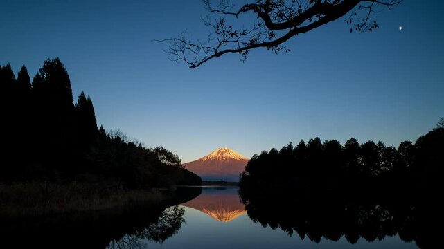 Timelapse of mount Fuji from Lake Tanuki at sunset with beautiful reflection, Shizuoka, Japan
