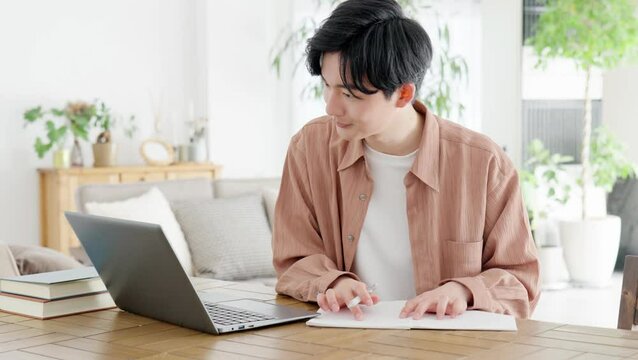 自宅で資格の勉強をする男性