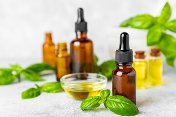 Basil essential oil on a textured wooden background. Basil essential oil and fresh leaves. Aromatherapy. Aroma oil. Medical herbs. Alternative medicine. Place for text. Copy space.