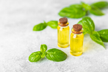 Basil essential oil on a textured wooden background. Basil essential oil and fresh leaves. Aromatherapy. Aroma oil. Medical herbs. Alternative medicine. Place for text. Copy space.