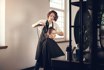 Salon, haircut and style with woman, customer and hair dryer for grooming or wellness. Fashion, client and product with hairdresser, beautician at work with employee for startup haircare service
