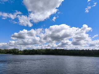 beautiful clouds in the sky over the river and forest