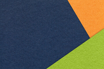 Texture craft navy blue color paper background with orange and green border. Vintage abstract denim cardboard.