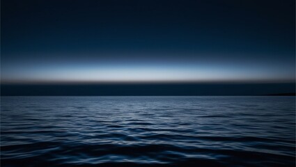 A vast expanse of water under a dark, almost pitch-black sky. The water received light. This creates a gradient effect from dark blue to lighter shades as the foreground approaches.