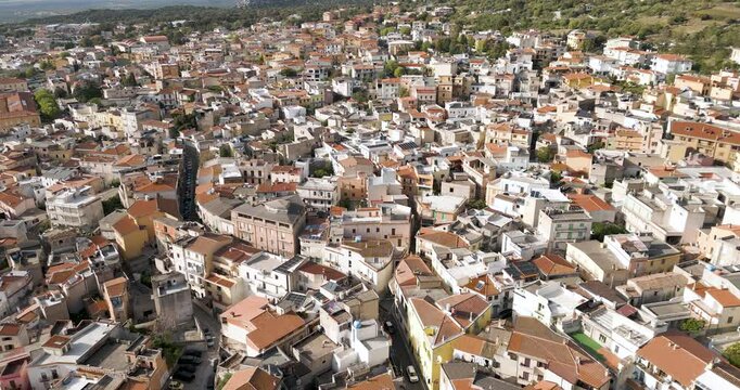 Old Houses And Mountains At Dorgali In Sardinia, Italy. Pull Back Aerial Shot.