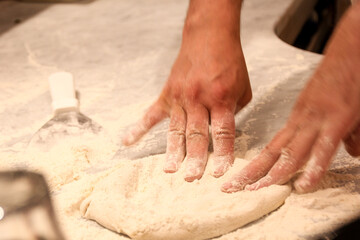 hands kneading dough