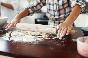 Dough, hands or kid baking with pin and flour in kitchen for child development to prepare cookies in home. Skills, closeup or baker learning pastry recipe for lunch meal, cooking snacks or dessert