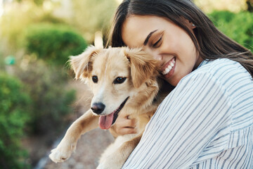 Hug, happy and woman with dog in nature for bonding with pet animal in outdoor garden with love. Care, smile and female person embracing and holding cute puppy for adoption at rescue center in Mexico