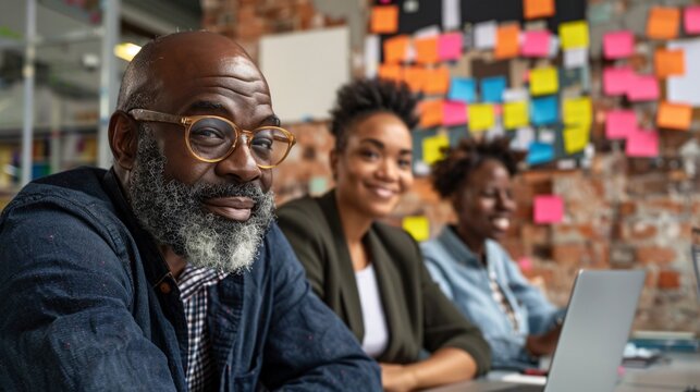 Colleagues sharing teaching resources and materials during a meeting Stock Photo with copy space