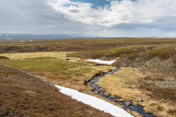 A small creek flowing through vast landscape in the Varangerhalv&oslash;ya National Park, Varanger Peninsula, Northern Norway