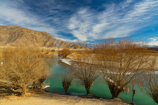 View of a beautiful landscape of Indus River flowing with a tree on its banks