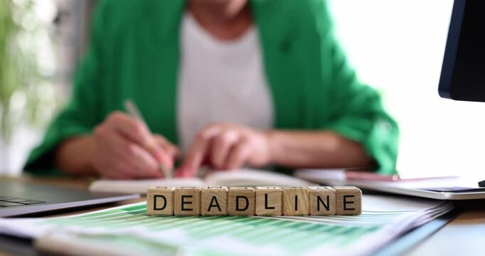 Business woman working in office and text deadline text. Concept of time management and deadlines