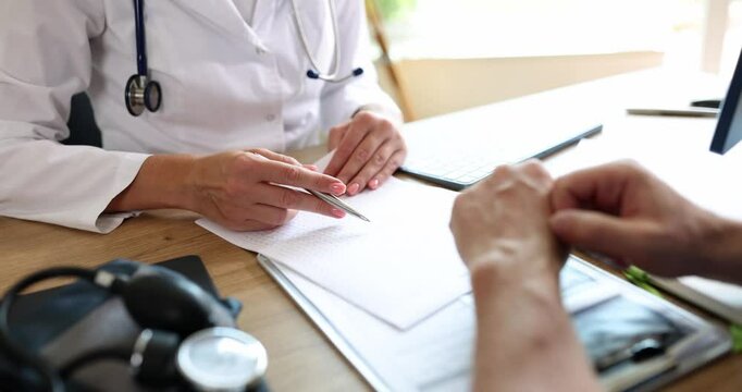 Doctor and patient discussing medical diagnosis in clinic. Medical care insurance and maintenance
