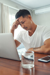 Naklejka premium Home, laptop and man stress, headache or worry for debt review, bankruptcy or reading email of financial fail. Confused freelancer with depression, sad or tired on computer for job search to pay rent