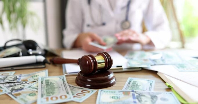 Therapist is counting cash and judge gavel. Corruption in healthcare and criminal liability