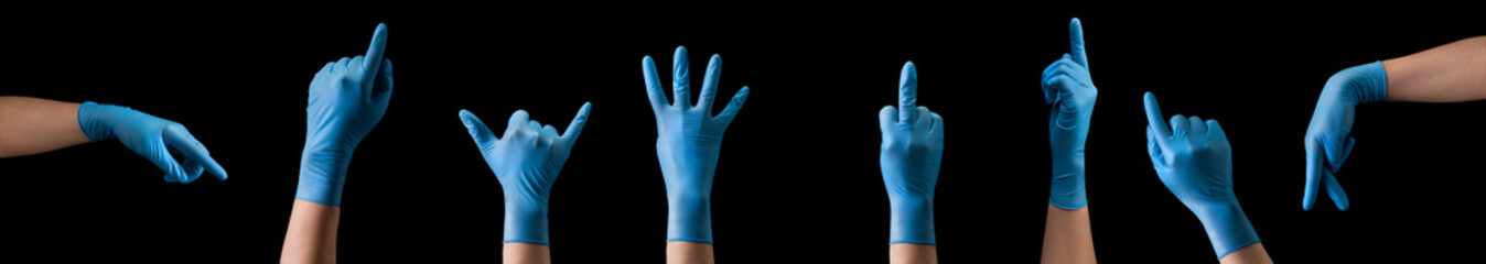 Doctor's hand in sterile medical gloves showing gesture or something on black